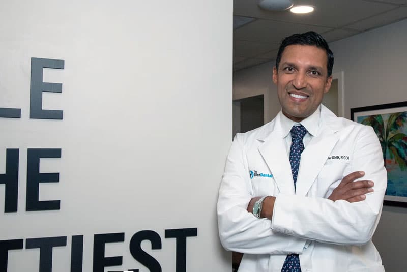 aman bhullar in front of sign at glen dental