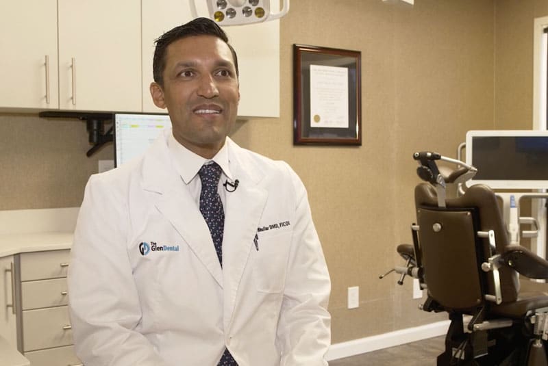 aman bhullar looking at patient discussing treatment