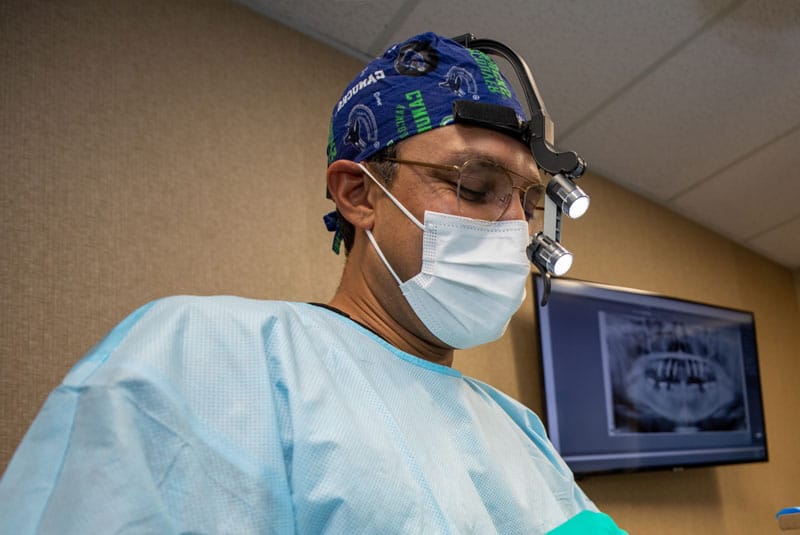 bhullar performing surgery on dental patient