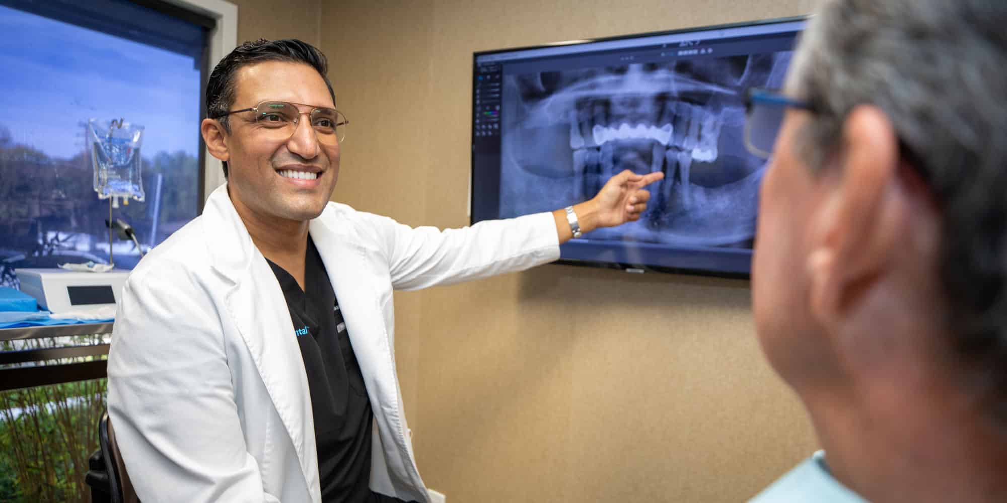 bhullar pointing at xray after consultation