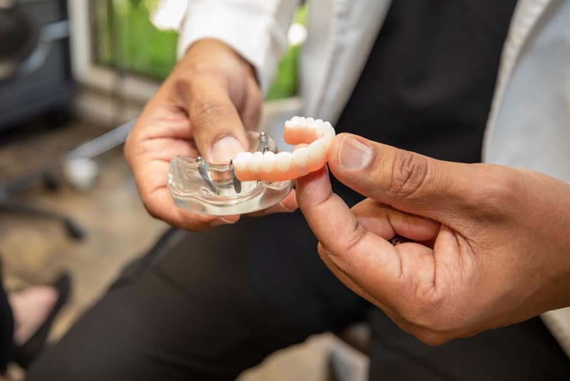 Dentist holding a dental model