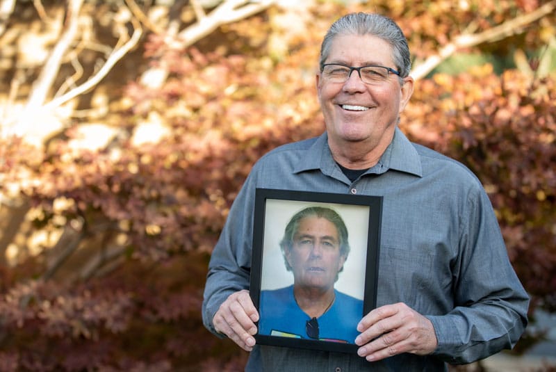 dental implant patient terry smiling with before photos