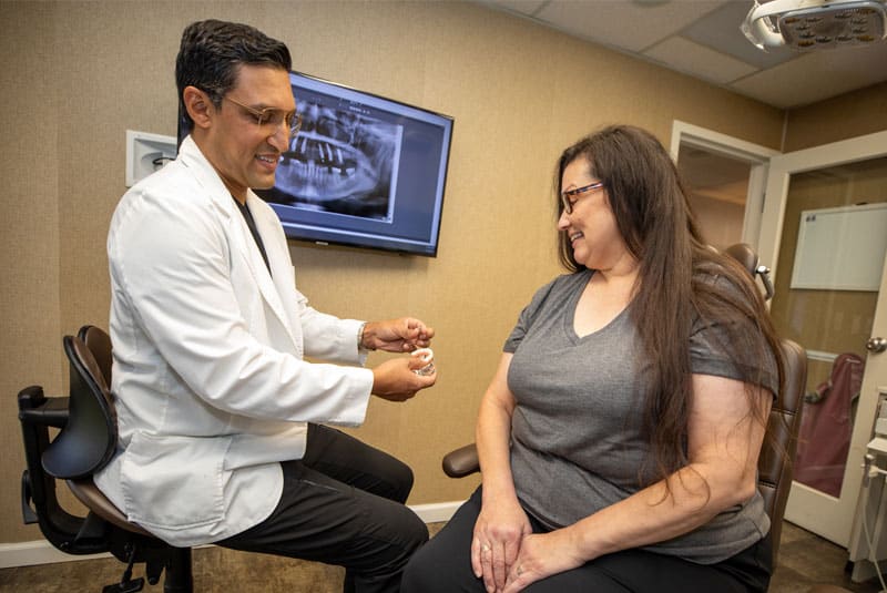 dr aman talking to patient before dental implants