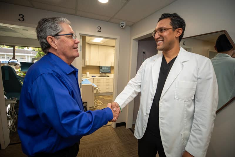 dr bhullar shaking handswith_terry a dental implant patient