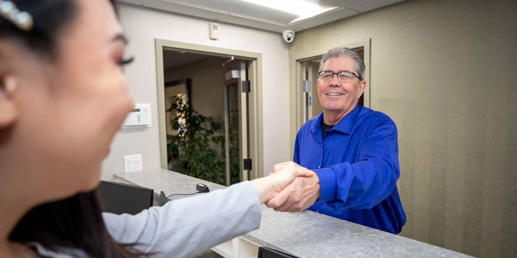 terry with dental office assistant in pinnacle dental lobby