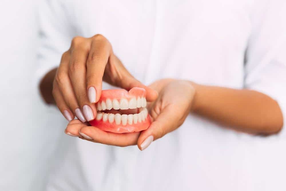 dentist holding dental model